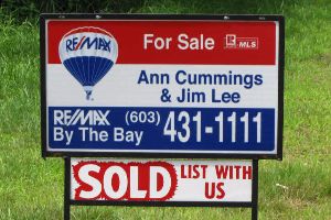 Ann Cummings and Jim Lee's sold sign in front of a home.